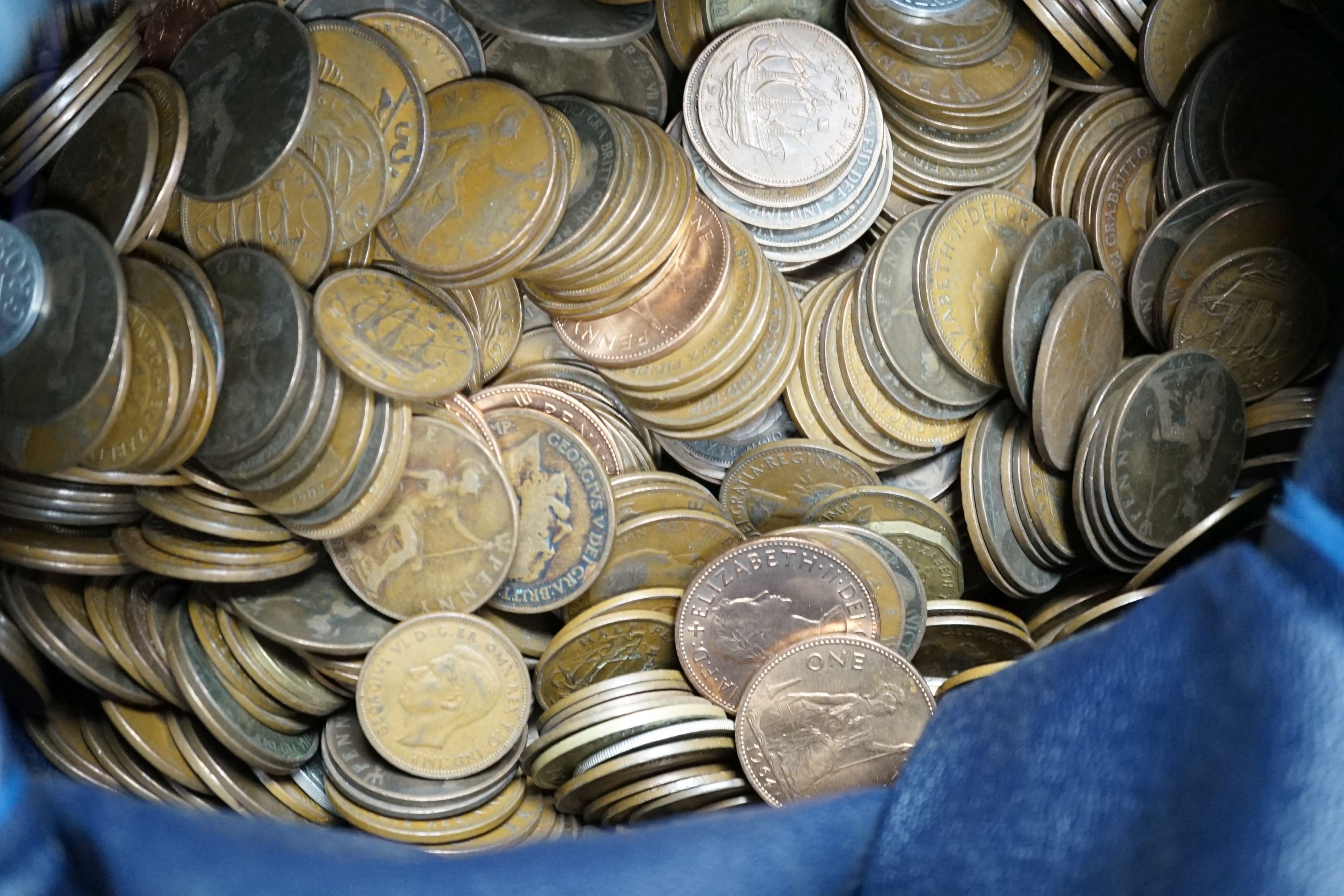 A large bag of UK pennies, coins and a bottle of sixpences